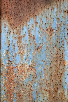 abstract pattern of rusty metal with peeling blue paint