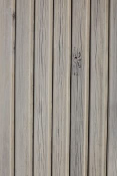 vertical picture of old vertical planks with fading brown paint