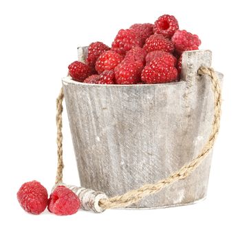 Fresh raspberry in the wooden bucket