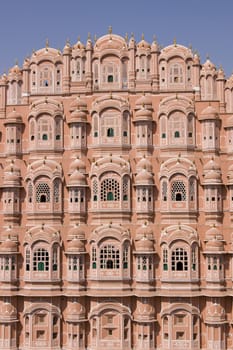 Hawa Mahal or Palace of the Winds. Ornate pink facade built to allow ladies of the Royal Court to look into the street without being seen. Jaipur, Rajasthan, India