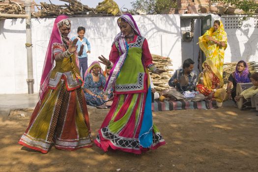Beautiful tribal dancers in colorful costume performing in Jaipur, Rajasthan, India