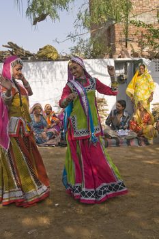 Beautiful tribal dancers in colorful costume performing in Jaipur, Rajasthan, India