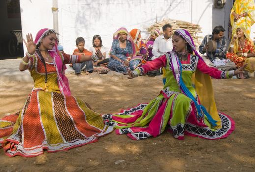 Beautiful tribal dancers in colorful costume performing in Jaipur, Rajasthan, India