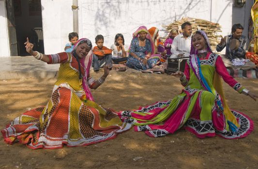 Beautiful tribal dancers in colorful costume performing in Jaipur, Rajasthan, India