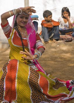 Beautiful tribal dancer in colorful costume performing in Jaipur, Rajasthan, India