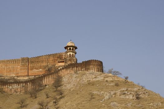 Massive fortified walls of Jaigarh Fort on a hill above Amber Fort. Jaipur, Rajasthan, India.