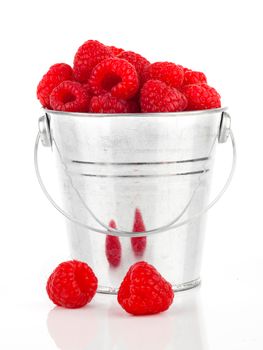 raspberries berries in a metal bucket, isolated on white background