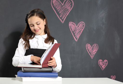 Girl in school uniform on a black background plate