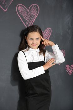 Girl in school uniform on a black background plate