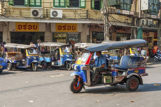 tuk tuk taxis on street in bangkok thailand