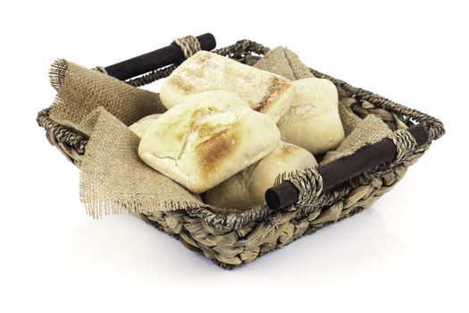 fresh baked buns in a basket on white background
