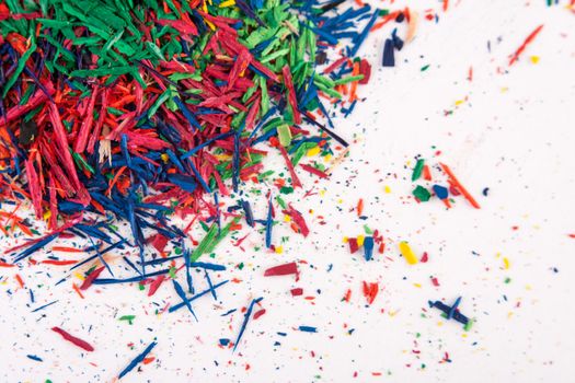 pencil shavings of different colors on white