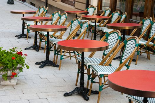 red elegant restaurant tables with chairs placed outdoors