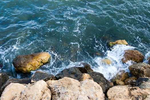 blue sea coast wit rocks shot from above