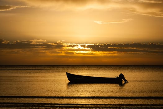 early morning sunrise over sea with boat