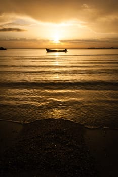 early morning sunrise over sea with boat