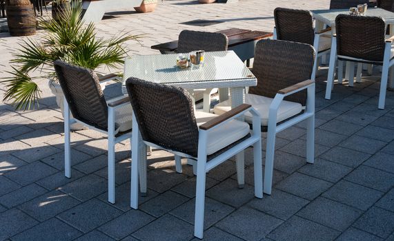 elegant restaurant tables with chairs placed outdoors