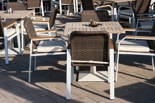 elegant restaurant tables with chairs placed outdoors