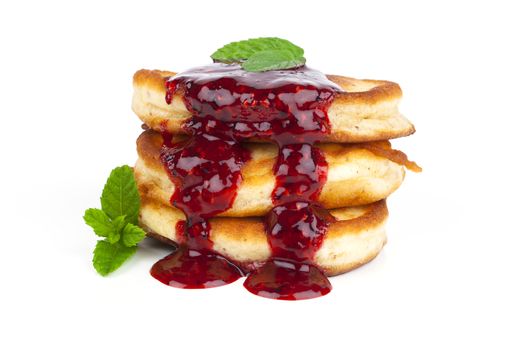 Delicious pancakes with raspberries sauce, on white background