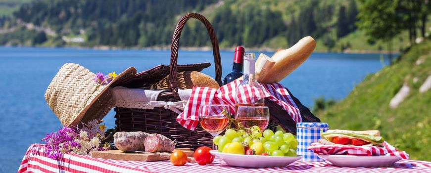 Picnic in french alpine mountains with lake on background, panoramic view