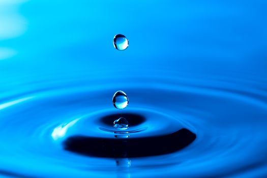 Splash of water crown on blue surface