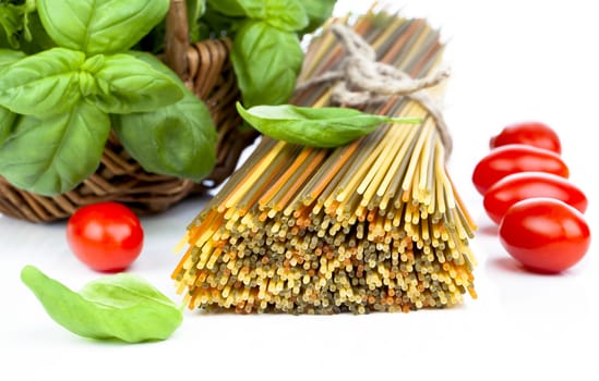 Spaghetti with  tomatoes, and fresh basil leaves. on white background