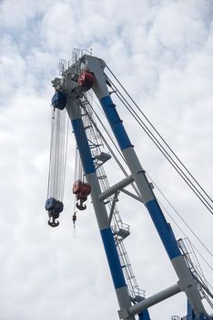 very big crane in rotterdam harbor with pulleys and steel cables