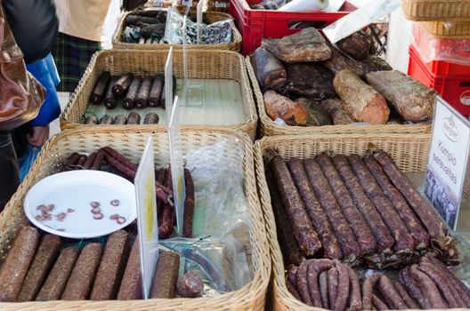 smoked sausage products put in wicker baskets sold and tasted at the market