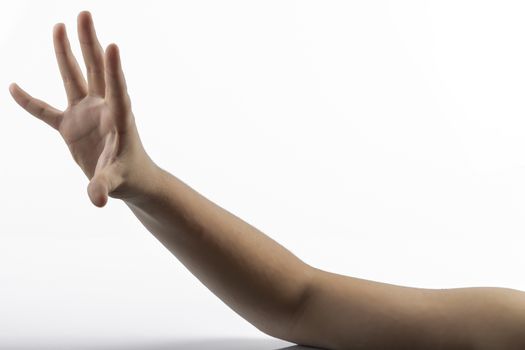 Young hands makes a gesture in rock-paper-scissors game: paper sign