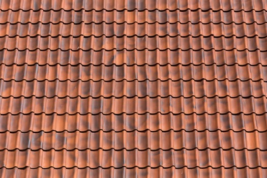 Red tiles roof background texture of a house