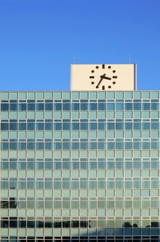 Clock on the top of glass building in Japan