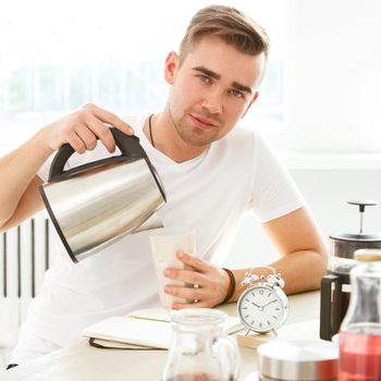 Morning. Young man by the table