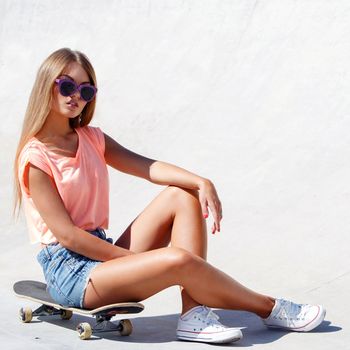 Outdoor, street. Attractive girl on the skateboard
