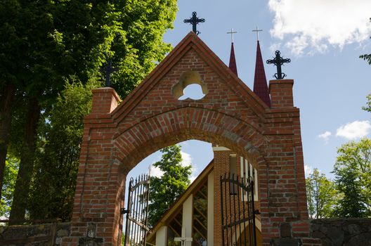 gothic church entrance door with crosses in summer time