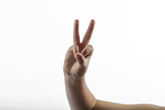 Young hands make a 2 fingers gesture