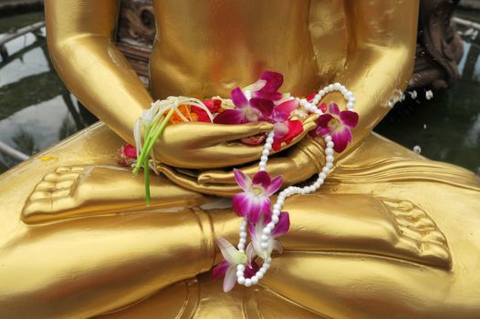 flower in hand image of buddha in Songkran festival, Thailand.