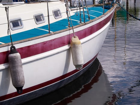 Reflection of an anchored yacht in the water sailing background    