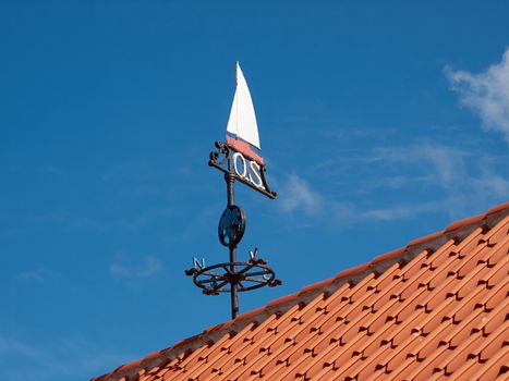 Traditional marine weather vane in a marina port