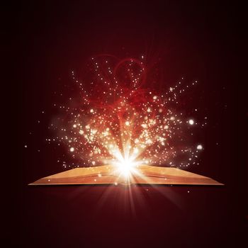 Old open book with magic light and falling stars. Dark background