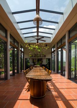 Tropical style dining room with skylight