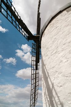 Shot of old white windmill with black wing