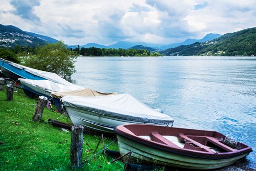 Lugano Lake, boats at rest on the grass in summer season, Switzerland