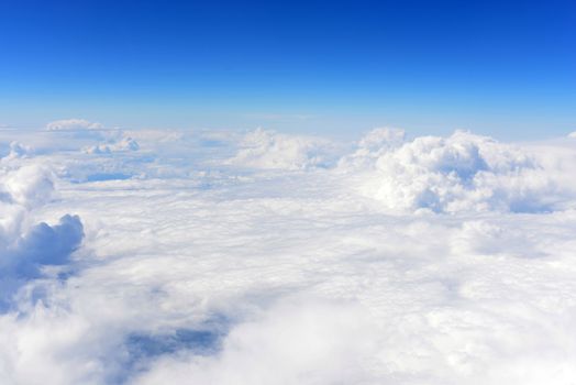 Blue sky and clouds. Top view of aircraft