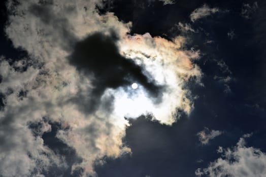 Dark sky. Clouds and sun. Natural background