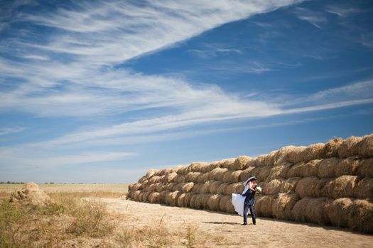 couple in the field with hay