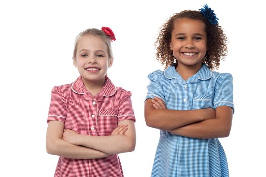 Confident school girls posing together, folded arms