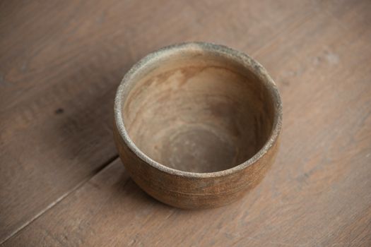 Traditional handcrafted dish of brown color on the table