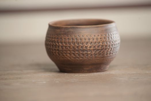 Traditional handcrafted dish of brown color on the table