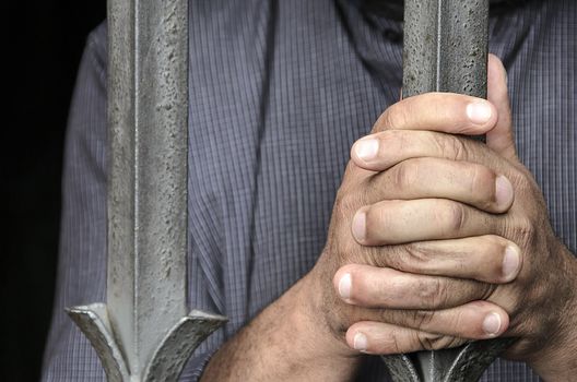 Workers barricaded behind bars for protesting the poor working conditions.