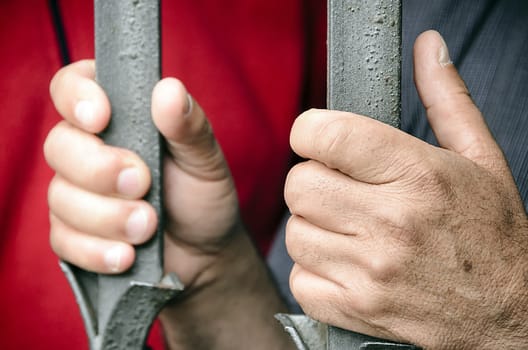 Workers barricaded behind bars for protesting the poor working conditions.